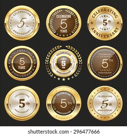 Collection of glossy gold 5th anniversary badge