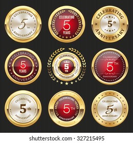Collection of glossy gold and red 5th anniversary badges