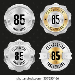 Collection of glossy silver 85th anniversary badges