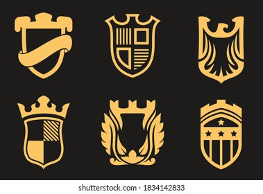 Sammlung goldener, heraldischer Embleme einzeln auf schwarzem Hintergrund. Vorlage für Schilder im minimalistischen Cartoon-Stil. Set von Premium Vintage Vektorgrafik.