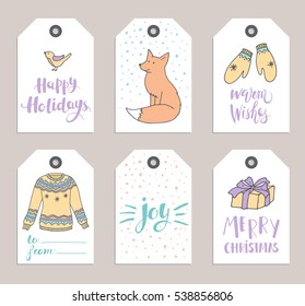 Collection of hand drawn cute winter tags in pastel colors. Christmas theme. Bird, fox, mittens, sweater, gift, snow and lettering