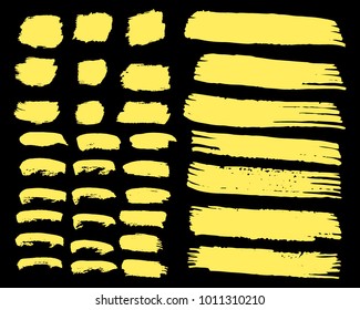 Collection of hand drawn golden grunge brushes. Vector Grunge Brushes. Dirty Artistic Design Elements. Creative Design Elements. Dark background. Distress Frame, Logo, Banner, Wallpaper.