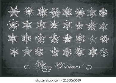 Collection of hand drawn white chalks sketch doodle snowflakes on blackboard background. Vector doodle sketch illustration 