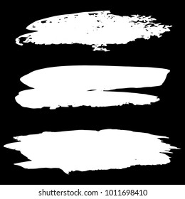 Collection of hand drawn white grunge brushes. Vector Grunge Brushes. Dirty Artistic Design Elements. Creative Design Elements. Banner. Black background with white stripes made with brush.