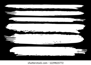 Collection of hand drawn white grunge brushes. Vector Grunge Brushes. Dirty Artistic Design Elements. Creative Design Elements. Black background. Distress Frame, Logo, Banner, Wallpaper. - Shutterstock ID 1229823772