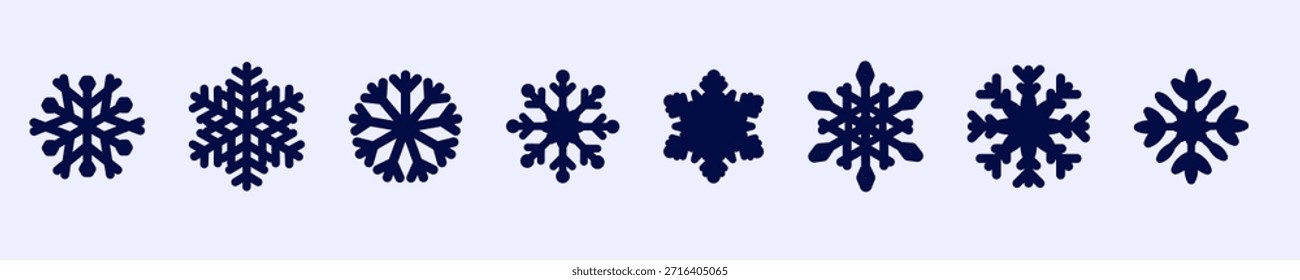 A collection of intricately designed snowflakes displayed on a soft, muted background.