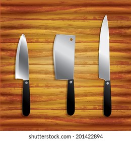 Collection of kitchen knives isolated on wooden background 