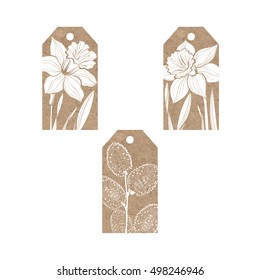 Collection of  kraft paper tags with spring flowers daffodils and twigs willow.