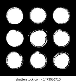 Collection of miscellaneous circle grunge brush strokes in white isolated over black background. Set of design elements. Vector illustration.
