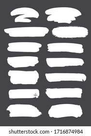 Collection of miscellaneous grunge brush strokes in white isolated over dark grey background. Set of design elements. Vector illustration.