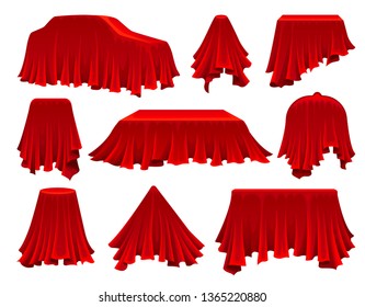 Collection of objects hidden under red cloth.