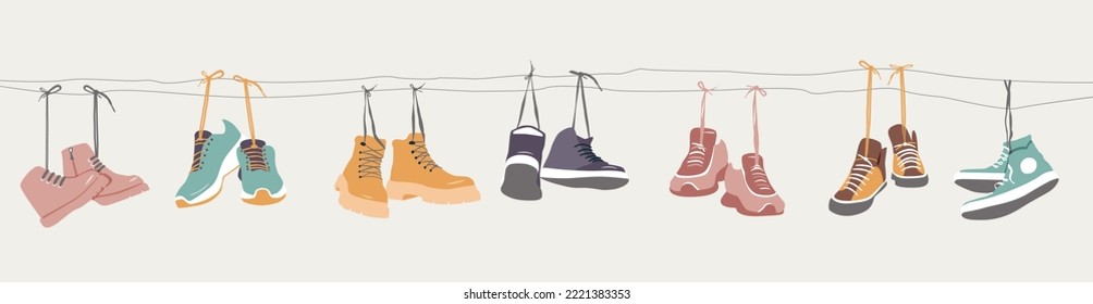 Collection of shoes hanging on shoelaces.