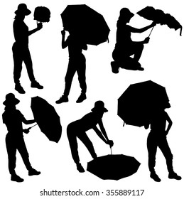 Collection of silhouettes of girls with umbrellas in different poses on white background