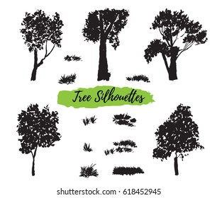 Collection of silhouettes of trees and herbs, hand-painted with watercolors on white background. The vector format.