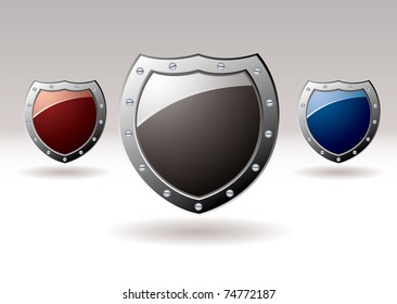 Collection of three metal shields with colored centers for text
