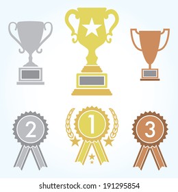 A collection of trophies and ribbons for first, second, and third place contestants.