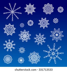 Collection of various white snowflakes on  the blue background