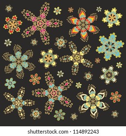Collection of vector decorative snowflakes, floral stars on black background