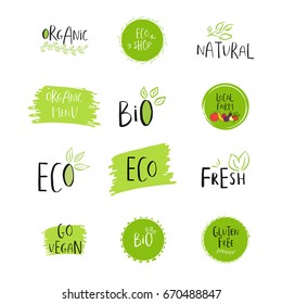 Collection of vector eco, bio green logo or sign. Vegan, raw, healthy food badge, tag for cafe, restaurants, products packaging. Hand drawn leaves, branches with lettering. Organic design.