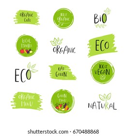 Collection of vector eco, bio green logo or sign. Vegan, raw, healthy food badge, tag for cafe, restaurants, products packaging. Hand drawn leaves, branches with lettering. Organic design.
