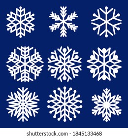 Collection of vector white snowflakes isolated on blue background. Template  for Christmas decoration. Vector illustration.