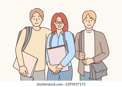 College friends with backpacks and workbooks smiling looking at camera for group photo with friends. Two men and woman enjoy spending time together after class on college or university campus