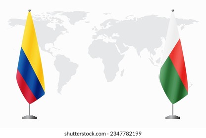 Colombia and Madagascar flags for official meeting against background of world map.