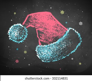 Color blue, white and red chalked vector sketch of Santa Claus hat on black chalkboard background. 