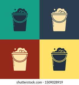 Color Bucket with foam and bubbles icon isolated on color background. Cleaning service concept. Vintage style drawing. Vector Illustration