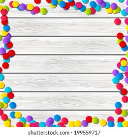 Color confetti on wooden background
