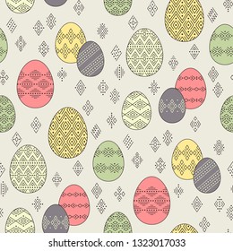 Color easter eggs with geometric ornament at ethnic style on beige background. Abstract seamless pattern for Easter design and decoration
