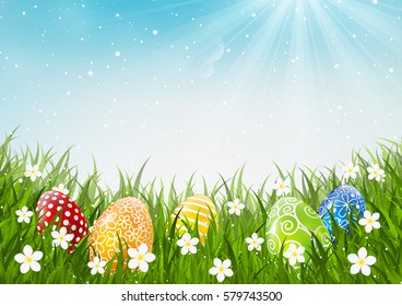 Color Easter eggs on green grass