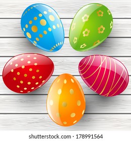Color Easter eggs on wooden background