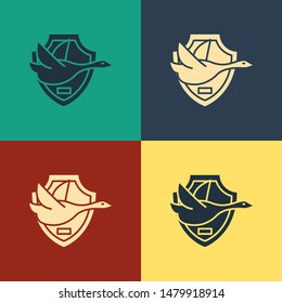 Color Flying duck on shield icon isolated on color background. Hunting trophy on wall. Vintage style drawing. Vector Illustration Color Flying duck on shield icon isolated on color background. Hunting trophy on wall. Vintage style drawing. Vector Illustration