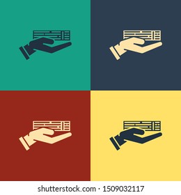 Color Hand holding deck of playing cards icon isolated on color background. Casino gambling. Vintage style drawing. Vector Illustration