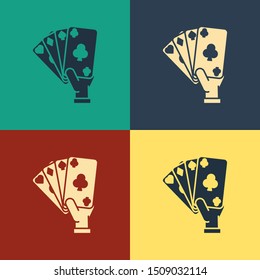 Color Hand holding playing cards icon isolated on color background. Casino game design. Vintage style drawing. Vector Illustration