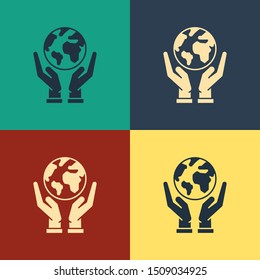 Color Human hands holding Earth globe icon isolated on color background. Save earth concept. Vintage style drawing. Vector Illustration