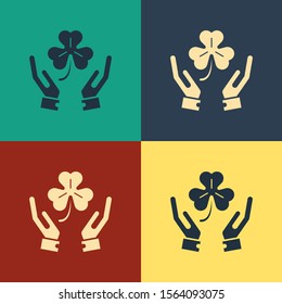 Color Human hands holding four leaf clover icon isolated on color background. Happy Saint Patrick day. Vintage style drawing. Vector Illustration