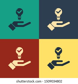 Color Light bulb in hand icon isolated on color background. Concept of idea. Vintage style drawing. Vector Illustration