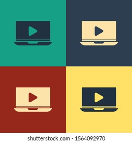 Color Online play video icon isolated on color background. Laptop and film strip with play sign. Vintage style drawing. Vector Illustration