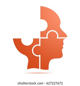 The color orange human head composed of orange puzzle pieces with gray shadow below the head on a white background. Incomplete human head composed of geometric elements 