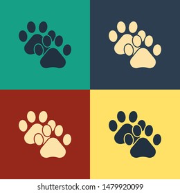Color Paw print icon isolated on color background. Dog or cat paw print. Animal track. Vintage style drawing. Vector Illustration