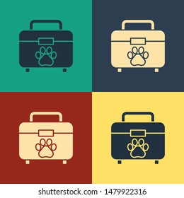 Color Pet first aid kit icon isolated on color background. Dog or cat paw print. Clinic box. Vintage style drawing. Vector Illustration