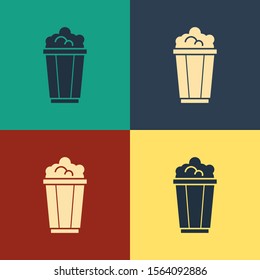 Color Popcorn in cardboard box icon isolated on color background. Popcorn bucket box. Vintage style drawing. Vector Illustration