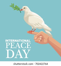 color poster hand holding in finger a pigeon with olive branch in peak international peace day text