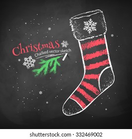 Color red and white chalk drawing of striped Christmas sock on black chalkboard background.