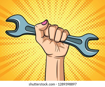 Color vector illustration in pop art style. Female hand with spanner on yellow halftone background. Horizontal poster for the International Labor Day. Women's rights, female power, discrimination