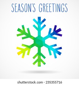 Colored abstract geometric snowflake with dropped shadow and handwritten season's greetings.