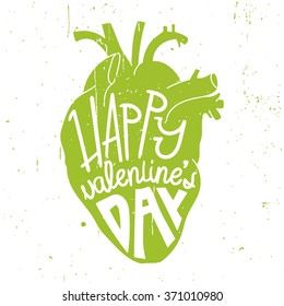 Colored anatomical human heart with text love. ironic greeting card for Valentine's day.