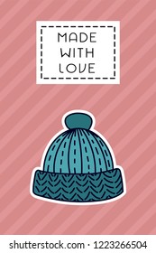Colored badge with knitted wool cap. "Made with love" sign on simple background. Simple knit / crochet emblem design. Doodle hand draw art. Wool handmade shop logo or tag for masters.